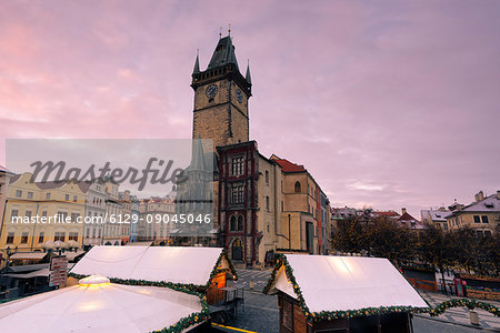 Prague, Czech Republic The clock tower in prague photographed at dawn, in the foreground Christmas stalls