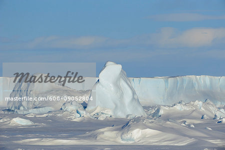 Sunlight reflecting on pack ice and an iceberg on Snow Hill Island at the Weddel Sea, Antarctic Peninsula in Antarctica