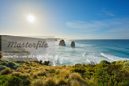 Scenic view of the limestone stacks of the Twelve Apostles backlit by the sun along the Great Ocean Road at Princeton in Victoria, Australia