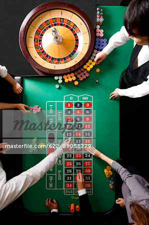People betting at casino table