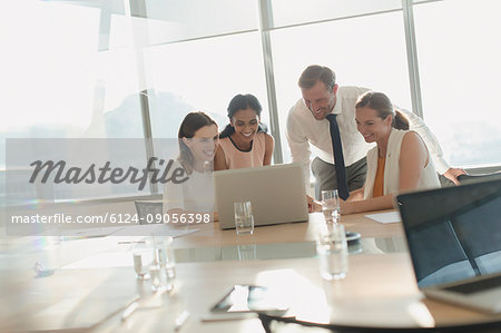 Business people working at laptop in conference room meeting