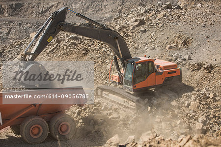 Quarry worker operating heavy machinery in quarry
