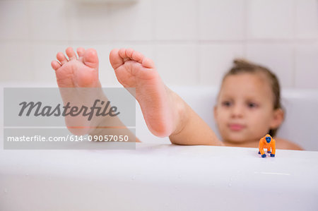 Girl with feet up relaxing in bath