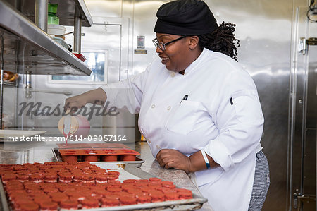 Chef in commercial kitchen preparing cakes