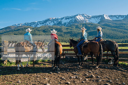 Rear view of cowboys and cowgirls on horseback, Enterprise, Oregon, United States, North America