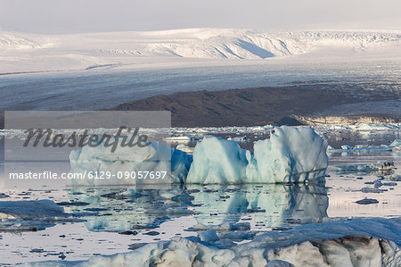 Floating icebergs and Vatnajokull Glacier on the background. Jokulsarlon Glacier Lagoon, Eastern Iceland, Europe