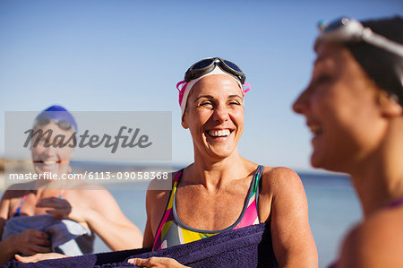 Laughing female open water swimmers
