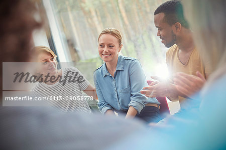 People clapping for woman in group therapy session