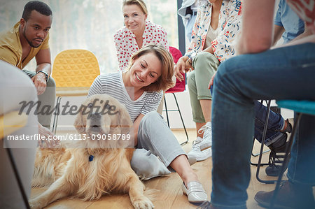 Woman petting dog in group therapy session