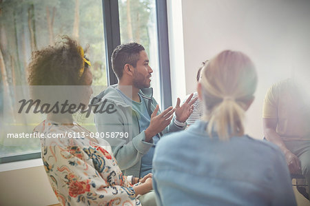 Man talking and gesturing in group therapy session