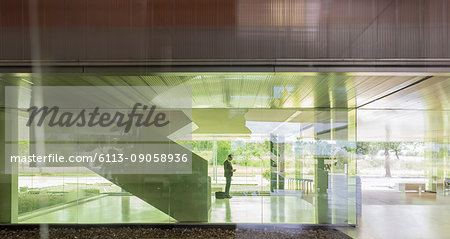 Silhouette businessman in modern office lobby