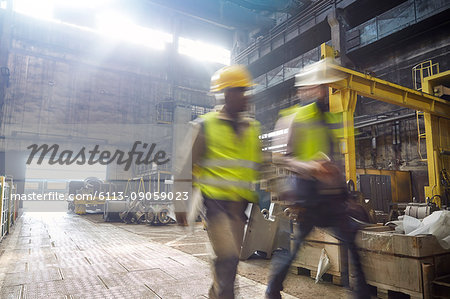 Steelworkers walking in steel mill