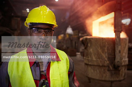 Portrait serious, confident steelworker in steel mill