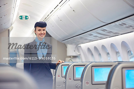 Portrait smiling, confident female flight attendant on airplane