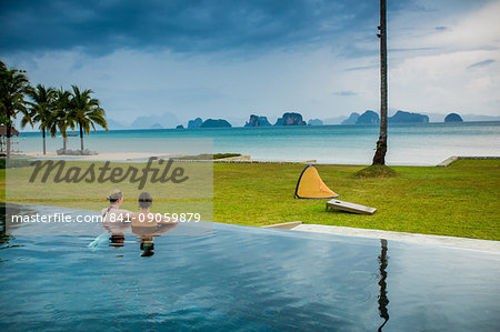 Couple relaxing in the pool on Koh Yao Noi Island, Thailand, Southeast Asia, Asia