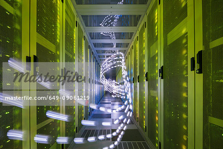 Interior of data centre, lights trails showing travelling data