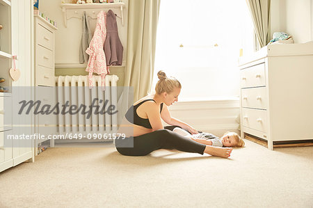 Pregnant woman and daughter in bedroom