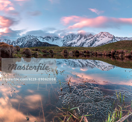 Panorama of pink clouds reflected in water at dawn, Tombal, Soglio, Bregaglia Valley, canton of Graubunden, Switzerland, Europe