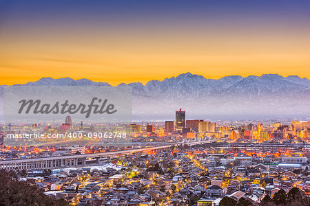 Toyama City, Japan downtown skyline with background mountains at dawn.
