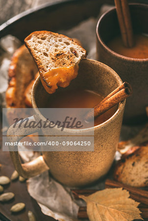 Roasted pumpkin soup with spices and cinnamon, rustic style