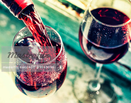 pouring red wine. Wine in a glass, selective focus, motion blur, Red wine in a glass. Sommelier pouring the wine into the glass. Thanksgiving Day, Valentine's day, date, love, Celebration.