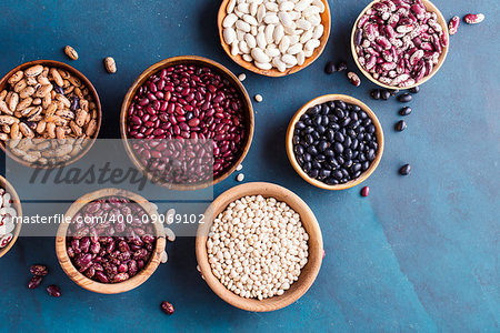 Assortment of beans on a blue background.