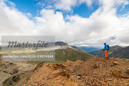 Hiker on the war trenches on rocky peaks, Filon Del Mott, Bormio, Braulio Valley, Stelvio Pass, Valtellina, Lombardy, Italy, Europe