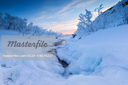 Sunrise on the frozen river and forest, Abisko, Kiruna Municipality, Norrbotten County, Lapland, Sweden, Scandinavia, Europe