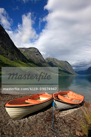 Boats pulled up on the shore of a fjord in the Fjordland region, western Norway, Scandinavia, Europe