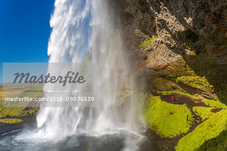 A waterfall cascade over a sheer cliff.