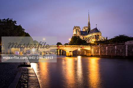 Notre Dame Cathedral and lights reflecting in the River Seine on a wet evening in Paris, France, Europe Notre Dame Cathedral and lights reflecting in the River Seine on a wet evening in Paris, France, Europe