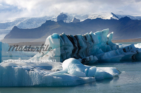 Icebergs on Jokulsarlon Glacial Lagoon, with mountains and glacier behind, South Iceland, Polar Regions