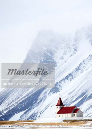 Church against snow covered mountains, winter afternoon, Snaefellsnes Peninsula, Iceland, Polar Regions