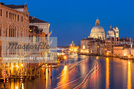 Grand Canal, and the church of Santa Maria della Salute, at night, with boat light trails, Venice, UNESCO World Heritage Site, Veneto, Italy, Europe Grand Canal, and the church of Santa Maria della Salute, at night, with boat light trails, Venice, UNESCO World Heritage Site, Veneto, Italy, Europe