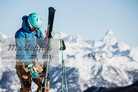 Skier preparing to put on skis