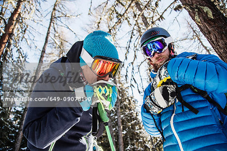 Two skiers standing together, outdoors, low angle view