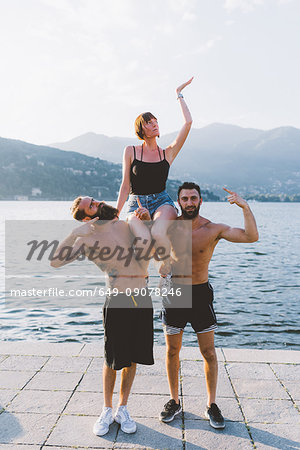 Portrait of three young hipsters posing at lake Como, Como, Lombardy, Italy