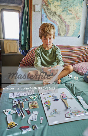 Boy cutting out pictures, Chuquisaca, Bolivia, South America