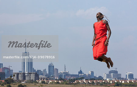 Masai warrior jumping in mid air during traditional dance, Nairobi, Kenya, Africa