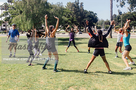 Schoolgirl soccer players warming up on school sports field