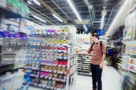 A tourist in a supermarket, a Caucasian man in Tokyo looking around.
