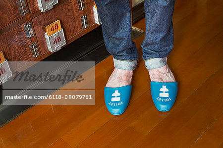 A person wearing Toilet slippers, plastic shower slippers on his feet.