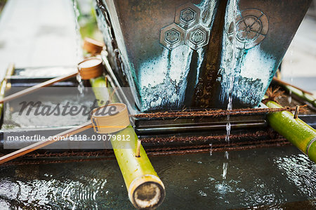 Close up of bamboo water hand washing basins at a Japanese Shinto Shrine.