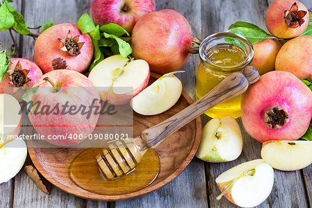 Apples, pomegranate and honey - symbols of judaic holiday Rosh Hashana (Jewish New Year). Selective focus.