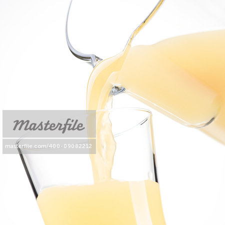 Pouring refreshing apple or lemon juice in a glass, healthy drinks concept