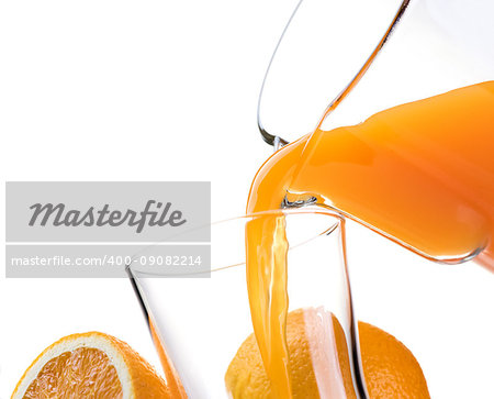 Pouring refreshing natural orange juice into a glass: nutrition and healthy drinks