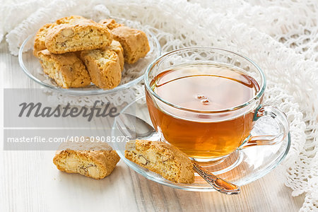 Transparent cup herbal tea with homemade cantuccini cookies