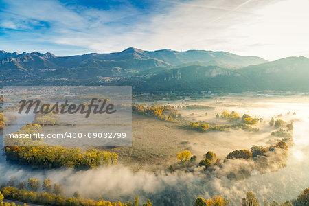 The Eden valley - View of the Adda river during a foggy morning, Airuno, Italy
