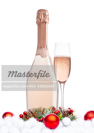 Bottle and glass of pink rose champagne with christmas decoration and gift on white background