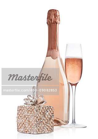 Bottle and glass of pink rose champagne with christmas decoration and gift on white background